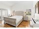 Well-lit bedroom with a king bed, wood floors, and lots of natural light at 4014 Gallagher Loop, Casselberry, FL 32707