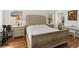 Cozy bedroom with hardwood floors, a tufted headboard, and lots of natural light at 4014 Gallagher Loop, Casselberry, FL 32707