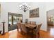 Formal dining room featuring seating for six, wood floors, and access to the pool at 4014 Gallagher Loop, Casselberry, FL 32707