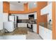 Well-equipped kitchen features stainless appliances, granite counters, and white cabinetry at 4014 Gallagher Loop, Casselberry, FL 32707