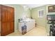 Bright laundry room with washer, dryer, and ample storage space at 4014 Gallagher Loop, Casselberry, FL 32707