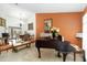 Elegant living room showcasing a piano, dining table, and sliding glass doors to the pool at 4014 Gallagher Loop, Casselberry, FL 32707