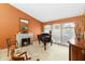 Bright living room featuring a fireplace, piano, and large windows at 4014 Gallagher Loop, Casselberry, FL 32707