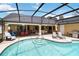 Spacious screened-in pool area with lounge chairs and an outdoor grill at 4014 Gallagher Loop, Casselberry, FL 32707