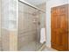 Elegant bathroom shower with glass block window and updated tile surround at 4014 Gallagher Loop, Casselberry, FL 32707
