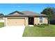 Charming single-story home with a well-manicured lawn and attached two-car garage at 58 Herring Ct, Poinciana, FL 34759