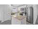 Modern kitchen featuring stainless steel appliances, granite countertops, and a central island at 58 Herring Ct, Poinciana, FL 34759