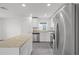 Bright kitchen with white cabinets, stainless steel appliances, and granite countertops at 58 Herring Ct, Poinciana, FL 34759