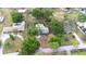 Aerial view of a beautiful home with a sparkling pool, surrounded by lush greenery and a spacious lot in a serene neighborhood at 7220 Pinehaven Dr, Lakeland, FL 33810