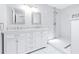 Stylish bathroom featuring double vanities, marble countertops, and a walk-in shower at 7220 Pinehaven Dr, Lakeland, FL 33810