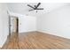 Bright bedroom featuring wood-look laminate flooring and a ceiling fan at 7220 Pinehaven Dr, Lakeland, FL 33810
