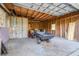 Unfinished garage featuring a lawn mower, work materials, and raw wooden walls, perfect for customization and storage solutions at 7220 Pinehaven Dr, Lakeland, FL 33810