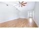 Bright living room with vaulted ceiling, ceiling fan, and wood-look laminate flooring at 7220 Pinehaven Dr, Lakeland, FL 33810