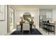 Bright dining area with a dark wood table, white chairs, and a stylish blue rug at 1321 Acorn Meadow Loop, Eustis, FL 32726