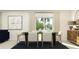 Bright dining room with a dark wood table, white chairs, and a stylish rug at 1321 Acorn Meadow Loop, Eustis, FL 32726