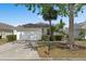Charming single-story home with attached garage, well-kept lawn, and mature trees at 146 Bayswater Ln, Davenport, FL 33897