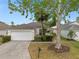 Charming single Gathering home featuring a well-manicured lawn and a two-car garage at 146 Bayswater Ln, Davenport, FL 33897
