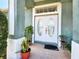 Elegant double front doors with glass oval inserts, potted plants, and a welcoming entrance at 2735 Berkford Cir, Lakeland, FL 33810