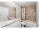 Bathroom featuring granite countertops, tiled shower-tub combination, and white cabinets at 350 N 1St Ave, Bartow, FL 33830