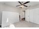 Bedroom featuring neutral walls, gray carpet, ceiling fan, and double door closet at 350 N 1St Ave, Bartow, FL 33830