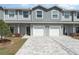 Charming townhome featuring a gray exterior, attached garage, and well-maintained landscaping at 350 N 1St Ave, Bartow, FL 33830