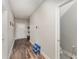 Inviting hallway featuring wood-look flooring, neutral walls, and access to a half-bathroom at 350 N 1St Ave, Bartow, FL 33830