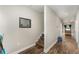 Inviting hallway featuring wood-look flooring, neutral walls, and stairs leading up to the next floor at 350 N 1St Ave, Bartow, FL 33830