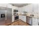 Modern kitchen featuring stainless steel appliances, granite countertops, and white cabinetry at 350 N 1St Ave, Bartow, FL 33830