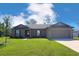 Charming single-story home featuring a well-manicured lawn and an attached two-car garage at 481 Danube Dr, Poinciana, FL 34759