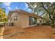 Back of home with a wooden backyard deck overlooking lush landscaping at 4915 Whiteoak E Dr, Lakeland, FL 33813