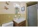 Bathroom with a green-tiled wall features a vanity sink with a shower to the right at 4915 Whiteoak E Dr, Lakeland, FL 33813