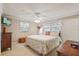 Relaxing bedroom with ceiling fan, natural light, and floral accents at 4915 Whiteoak E Dr, Lakeland, FL 33813