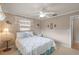 Well-lit bedroom featuring floral bedding, decorative window treatments, and ample space at 4915 Whiteoak E Dr, Lakeland, FL 33813
