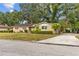 Charming single-story home with a well-manicured lawn and mature trees at 4915 Whiteoak E Dr, Lakeland, FL 33813