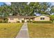 Lovely single-story house with a long walkway leading to the front door at 4915 Whiteoak E Dr, Lakeland, FL 33813