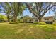 Well-manicured front yard with mature trees framing the home at 4915 Whiteoak E Dr, Lakeland, FL 33813