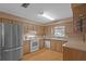 Efficient kitchen with stainless steel refrigerator and white appliances at 4915 Whiteoak E Dr, Lakeland, FL 33813