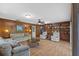 Spacious living room with wood paneling, built-in shelving, and comfortable sofas at 4915 Whiteoak E Dr, Lakeland, FL 33813