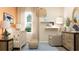 Serene Bedroom featuring a comfortable chair, crib, and elegant lighting at 2627 Skyline Loop, Kissimmee, FL 34758