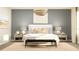 Stylish bedroom with elegant pendant lighting, modern decor, and a comfortable seating area at 2627 Skyline Loop, Kissimmee, FL 34758