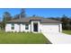 Charming single-story home with a well-manicured lawn, neutral paint, and a two-car garage at 368 Amberjack Ct, Poinciana, FL 34759