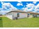 A spacious backyard with lush green grass and a well-maintained exterior at 3829 Corsican Pl, Lake Alfred, FL 33850