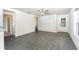 Bright and airy living room with gray wood flooring, white walls, and a view of the entrance at 3829 Corsican Pl, Lake Alfred, FL 33850
