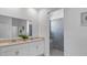 Bathroom boasting double sinks, quartz countertops, and an adjacent walk-in shower at 611 Terrapin Dr, Debary, FL 32713