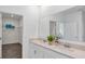 Bathroom featuring double sinks, quartz countertops, and a spacious walk-in closet at 611 Terrapin Dr, Debary, FL 32713