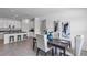 Open-concept dining area with dark wood table, light-colored chairs, and an adjacent kitchen at 611 Terrapin Dr, Debary, FL 32713