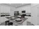 Bright kitchen featuring white cabinets, stainless steel appliances, an island, and stool seating at 611 Terrapin Dr, Debary, FL 32713