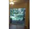 View from the living room, featuring the backyard's lush greenery visible through the sliding glass doors at 665 Oak Harbour Dr # 115, Altamonte Springs, FL 32701