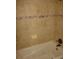 Relaxing bathtub features neutral tile surround and mosaic accents for a spa-like feel at 665 Oak Harbour Dr # 115, Altamonte Springs, FL 32701