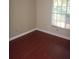 Bright bedroom with hardwood floors and natural light from a large window at 665 Oak Harbour Dr # 115, Altamonte Springs, FL 32701